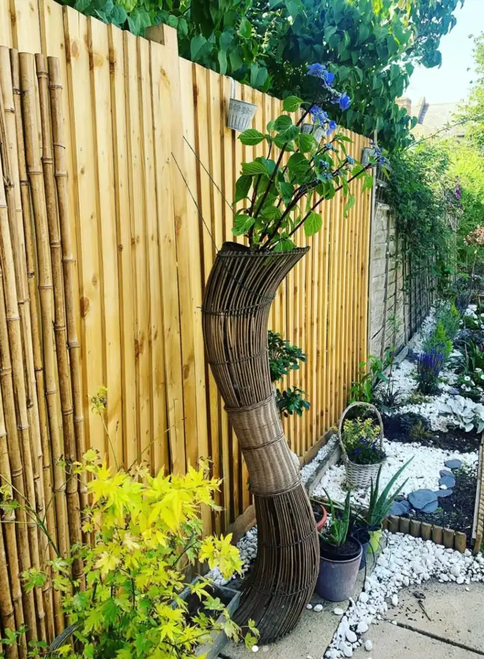 found sculptural wicker form by the fence